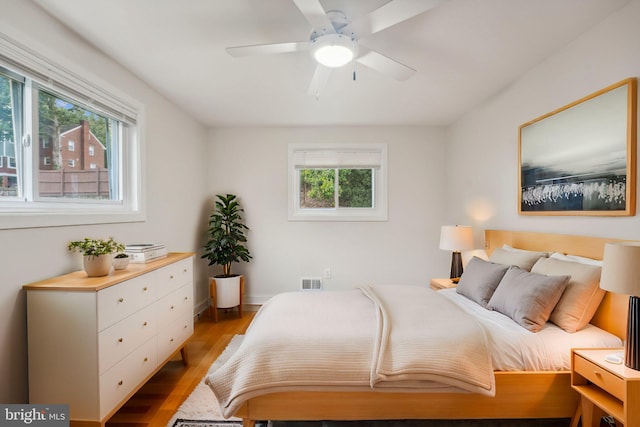 bedroom with light hardwood / wood-style floors and ceiling fan