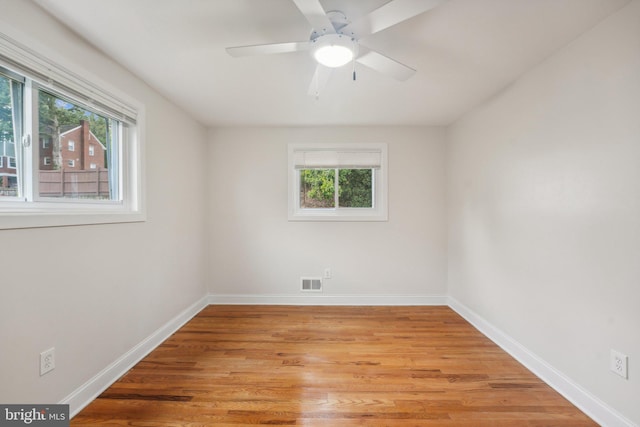 spare room with light wood-type flooring and ceiling fan