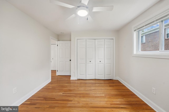 unfurnished bedroom with light hardwood / wood-style floors, ceiling fan, and a closet