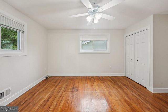 unfurnished bedroom featuring ceiling fan, a closet, and light hardwood / wood-style floors