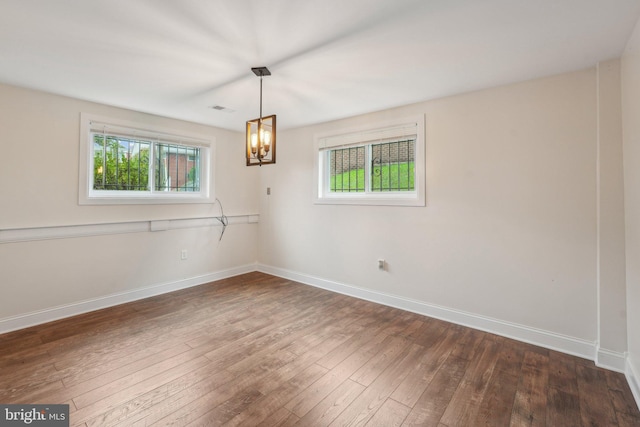 unfurnished room featuring dark wood-type flooring