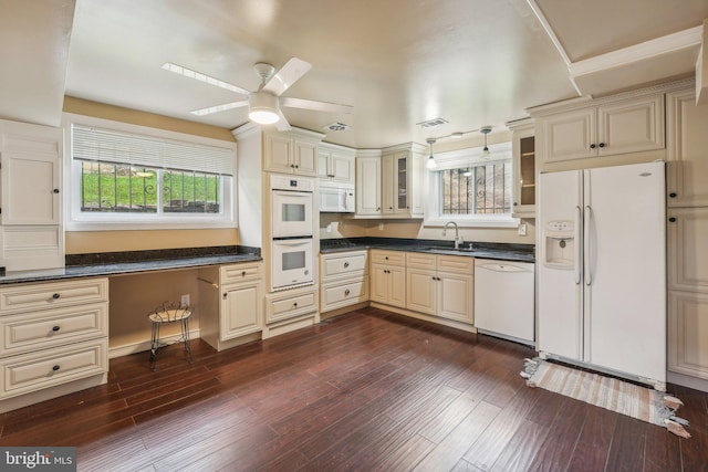 kitchen with white appliances, cream cabinets, ceiling fan, and dark hardwood / wood-style flooring