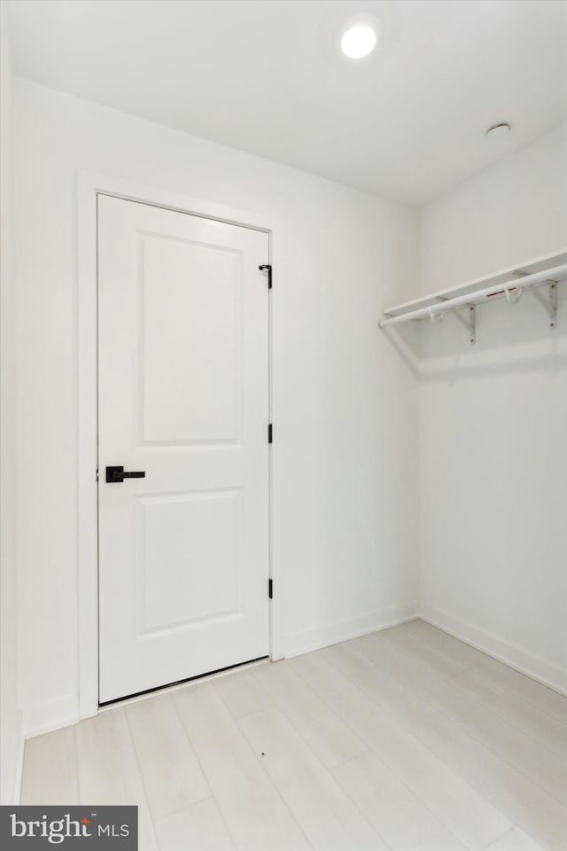 spacious closet with light hardwood / wood-style flooring