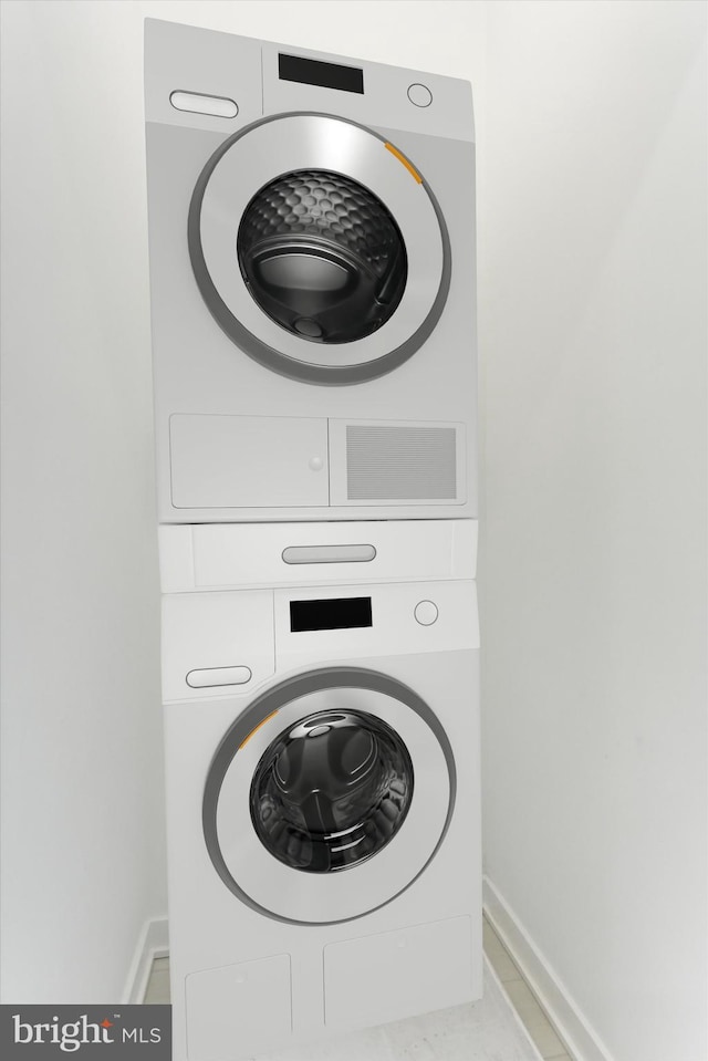 laundry area featuring stacked washer and clothes dryer