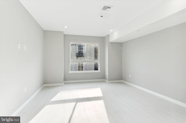 empty room with light hardwood / wood-style flooring