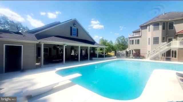 view of pool featuring a patio and a diving board