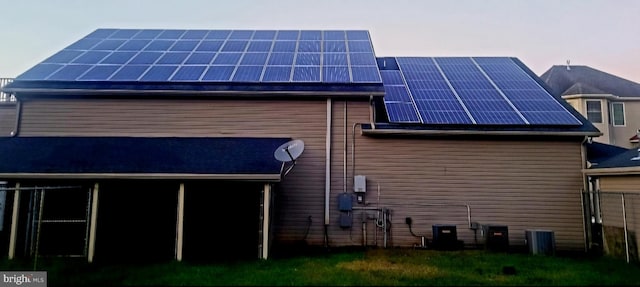 property exterior at dusk with solar panels