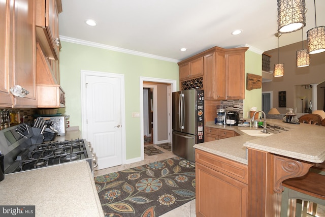 kitchen with kitchen peninsula, backsplash, crown molding, stainless steel refrigerator, and range with gas stovetop