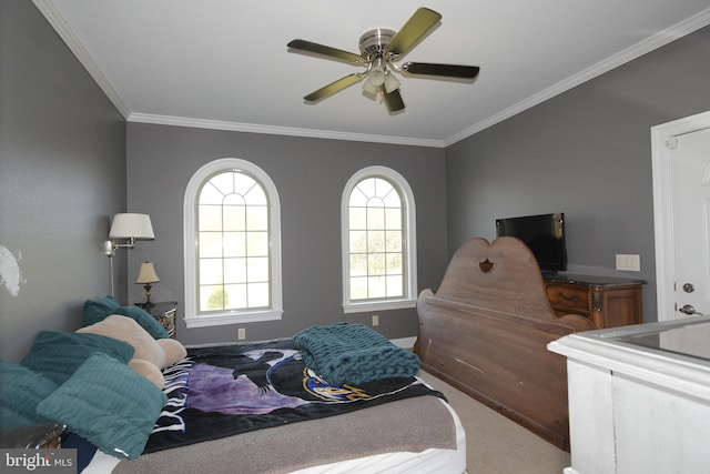 carpeted bedroom featuring ceiling fan and crown molding