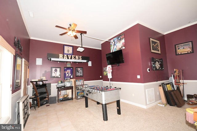 rec room with ceiling fan and crown molding