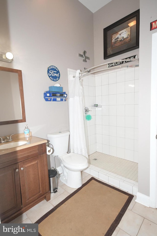 bathroom with tile patterned flooring, vanity, toilet, and walk in shower