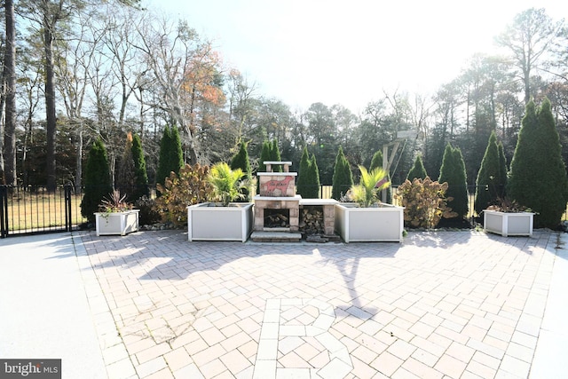 view of patio / terrace featuring an outdoor stone fireplace