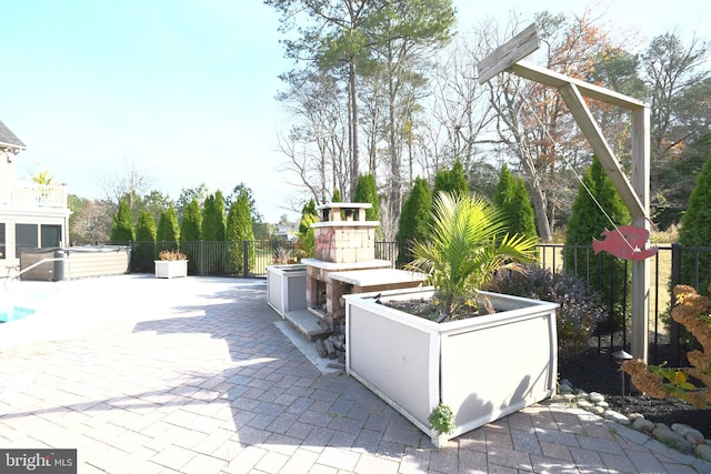 view of patio / terrace featuring an outdoor kitchen and exterior fireplace