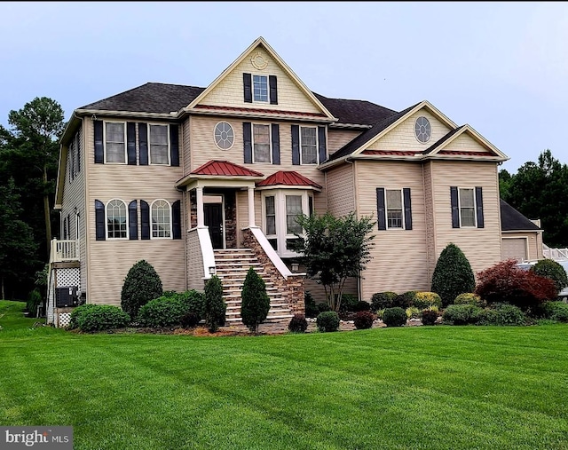 view of front of house with a front yard and cooling unit