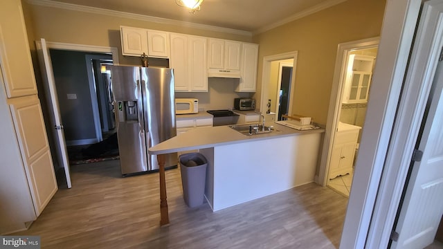 kitchen with white cabinetry, sink, stainless steel fridge with ice dispenser, light wood-type flooring, and ornamental molding