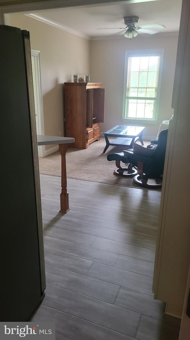 corridor with hardwood / wood-style floors and ornamental molding