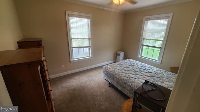 bedroom with carpet flooring, multiple windows, ceiling fan, and crown molding