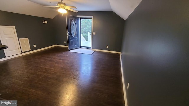 interior space with dark hardwood / wood-style flooring, vaulted ceiling, and ceiling fan