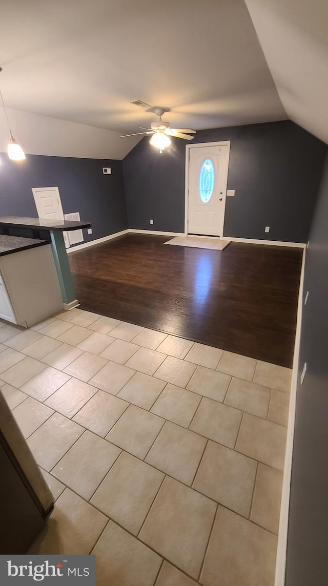 bonus room with ceiling fan, vaulted ceiling, and light wood-type flooring