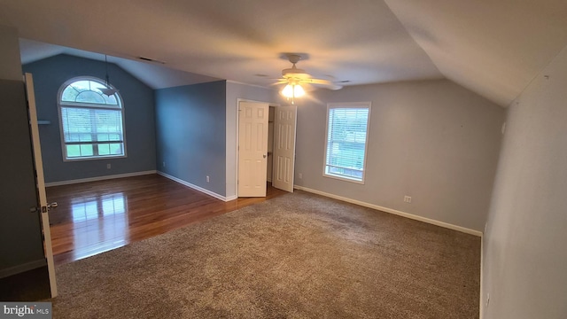 additional living space with ceiling fan, dark wood-type flooring, and vaulted ceiling