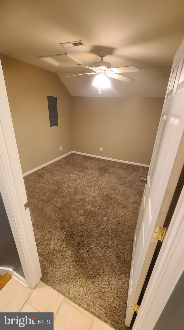 unfurnished room featuring carpet floors, electric panel, vaulted ceiling, and ceiling fan