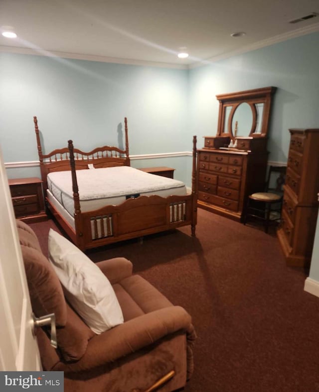 bedroom featuring dark colored carpet and ornamental molding