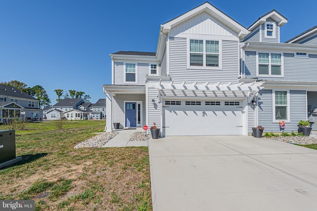 view of front of property with a pergola, a front yard, and a garage