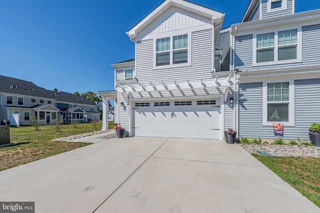 view of front facade with a pergola, a garage, and a front lawn