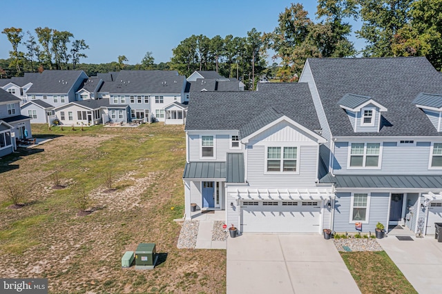 multi unit property featuring a front yard and a garage