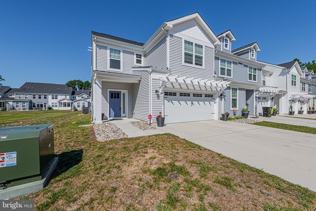 view of property featuring a front lawn and a garage