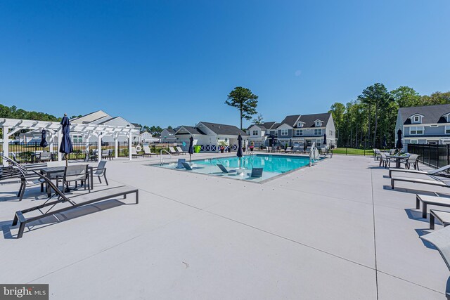 view of swimming pool featuring a pergola and a patio area