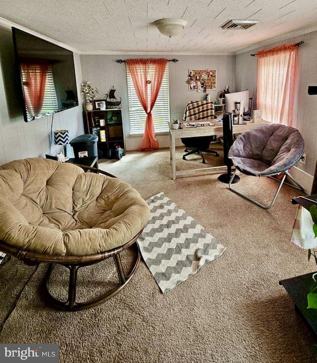 living room with crown molding, carpet flooring, visible vents, and a textured ceiling