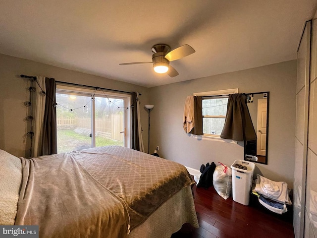 bedroom with ceiling fan, dark hardwood / wood-style flooring, and access to outside