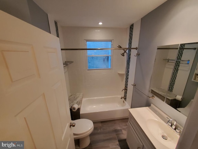 full bathroom featuring vanity, toilet, tiled shower / bath combo, and hardwood / wood-style flooring