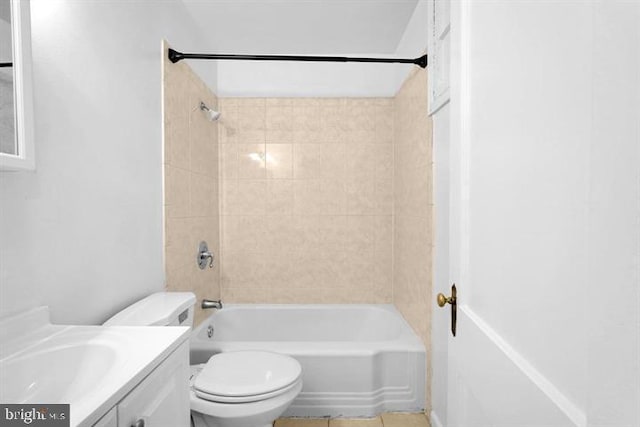 full bathroom featuring tiled shower / bath combo, vanity, and toilet