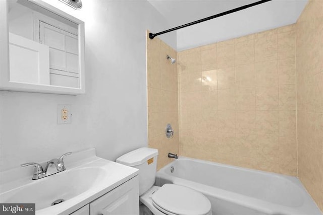 full bathroom with vanity, toilet, and tiled shower / bath