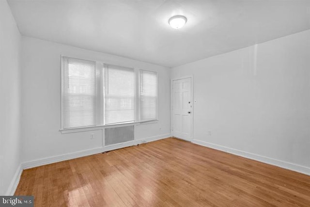 unfurnished room with hardwood / wood-style flooring