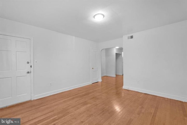 unfurnished room with light wood-type flooring