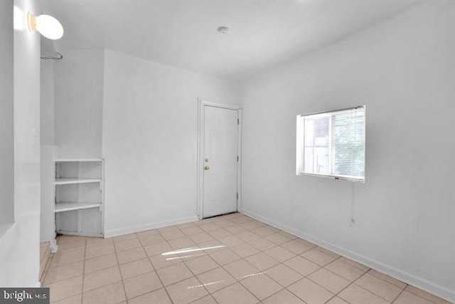 spare room featuring light tile patterned floors