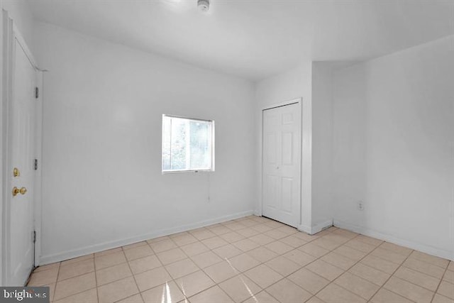 unfurnished room with light tile patterned flooring