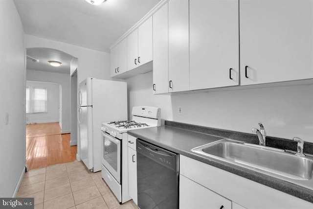 kitchen featuring white cabinets, sink, gas range gas stove, light hardwood / wood-style flooring, and black dishwasher