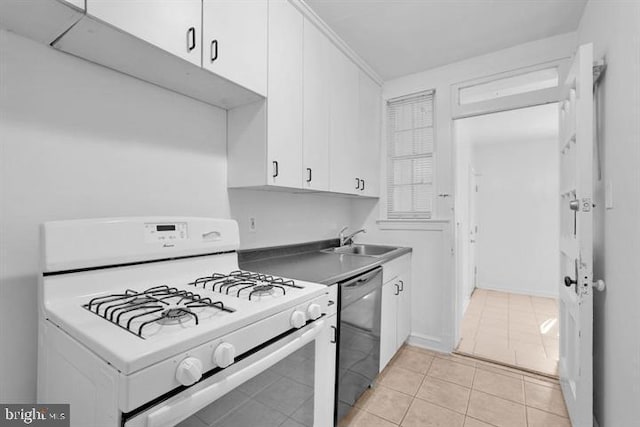 kitchen with black dishwasher, white gas stove, sink, white cabinetry, and light tile patterned floors