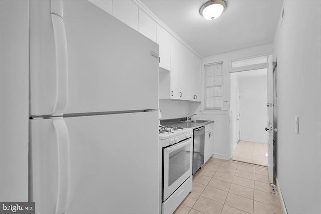 kitchen featuring white cabinets, white appliances, light tile patterned floors, and sink