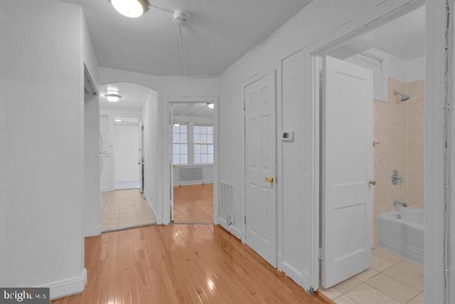 hallway with light hardwood / wood-style floors