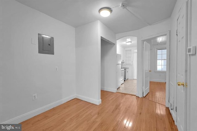 interior space with light hardwood / wood-style floors and electric panel