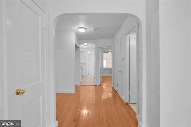 corridor with light hardwood / wood-style floors