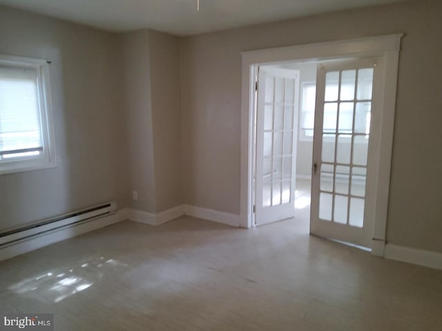 empty room featuring a baseboard heating unit