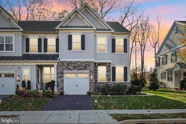 view of front facade with a garage and a yard