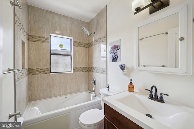 full bathroom with tiled shower / bath combo, vanity, and toilet