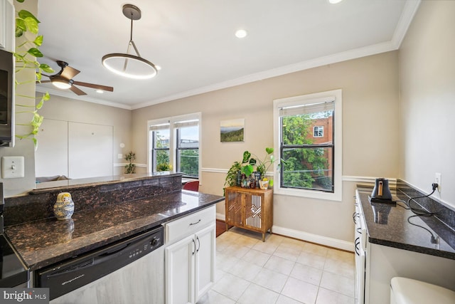 kitchen with dark stone countertops, white cabinets, dishwasher, and pendant lighting